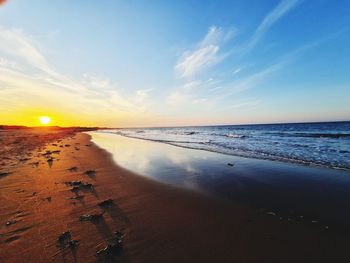 Scenic view of beach against sky during sunset