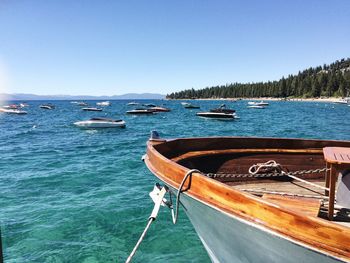 Boat moored at sea against clear blue sky 