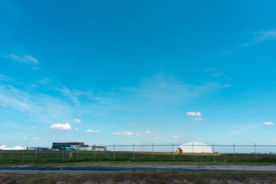 Scenic view of beach against blue sky