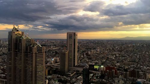 High angle view of city against cloudy sky