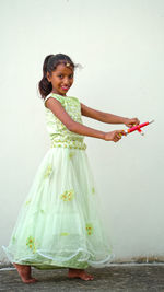 Indian beautiful little girl with garba sticks or dandiya on indian festival navratri.