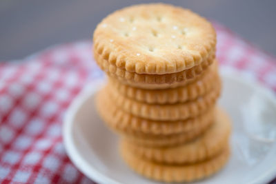 Close-up of stacked crackers in plate on table