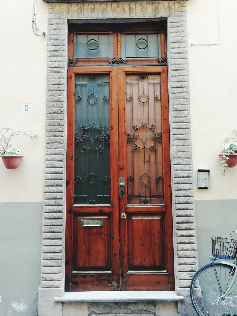 building exterior, architecture, built structure, door, building, entrance, no people, window, day, residential district, house, closed, outdoors, wood - material, communication, city, wall - building feature, safety, text, wheel