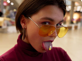 Close-up portrait of girl holding sunglasses