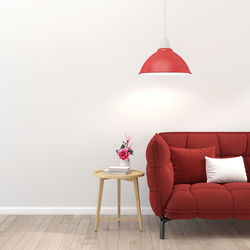 Red umbrella on table against wall at home