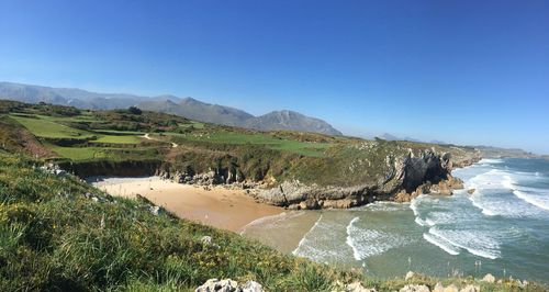 Scenic view of sea against clear blue sky