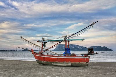 Ship moored on sea against sky