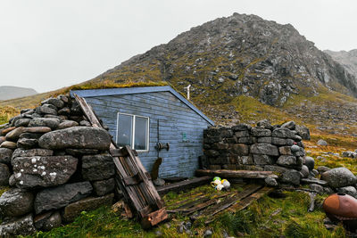 Blue wooden fishing cabin stokkvika at the beach in moskenesoya lofoten islands in norway.