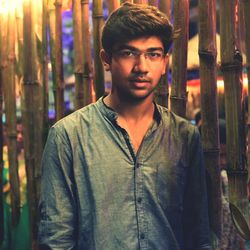 Portrait of young man standing at night