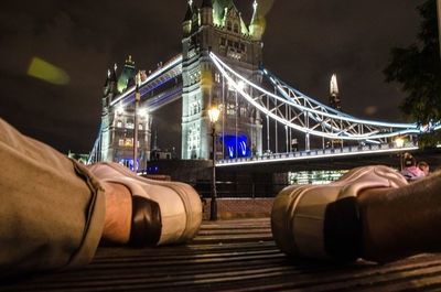 Midsection of illuminated bridge at night