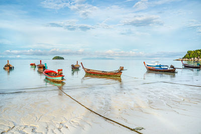 Boats moored on beach