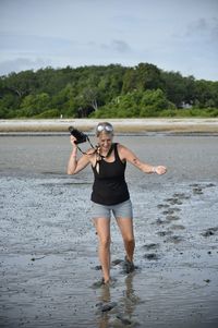 Woman photographer walking though the muddy sands on the beach of hilton head island