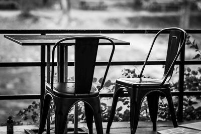 Empty chairs and table in park