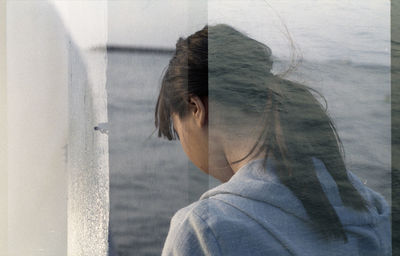 Multiple exposure of woman and man by sea