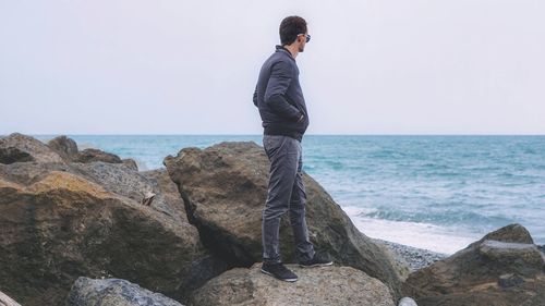 Man looking at sea against clear sky