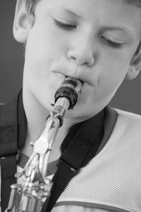 Close-up of boy playing saxophone