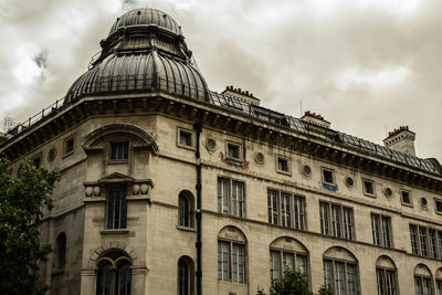 Low angle view of historic building against cloudy sky