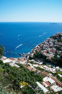 High angle view of townscape by sea against sky