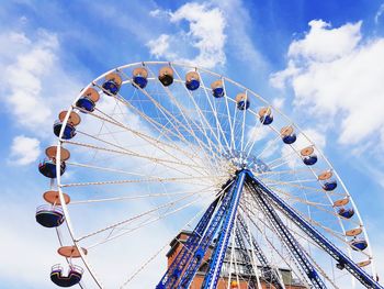 Low angle view of ferris wheel against sky