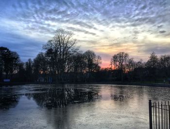 Scenic view of lake against cloudy sky