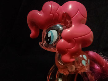 Close-up of toy over black background