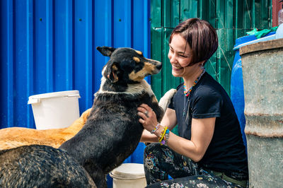 Dog at the shelter. animal shelter volunteer takes care of dogs. lonely dogs in cage with volunteer.