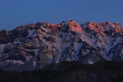 Low angle view of mountain against sky at sunset