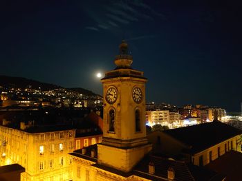 High angle view of illuminated buildings against sky at night