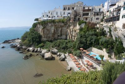 High angle view of buildings by sea