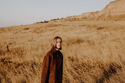 Portrait of woman standing on land against sky