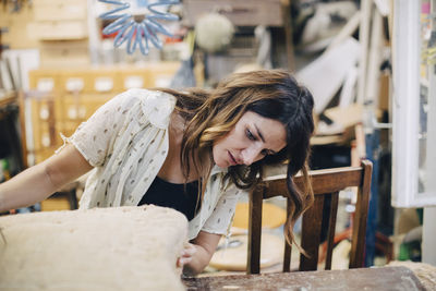 Portrait of happy woman working on wood