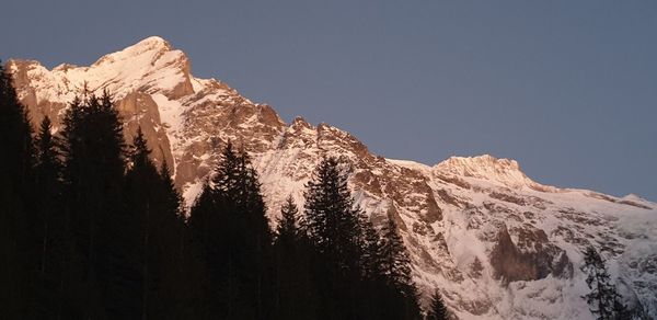 Scenic view of snowcapped mountains against clear sky