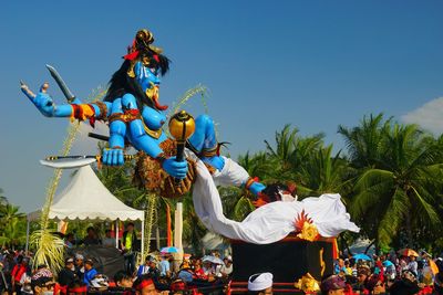 People in traditional clothing against blue sky