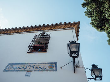 Low angle view of text on building against sky