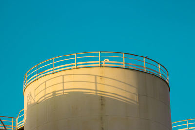 Low angle view of metal structure against blue sky