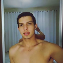 Portrait of shirtless mid adult man at home