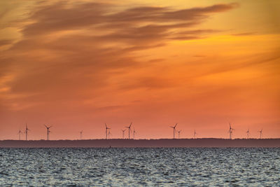 Scenic view of sea against orange sky