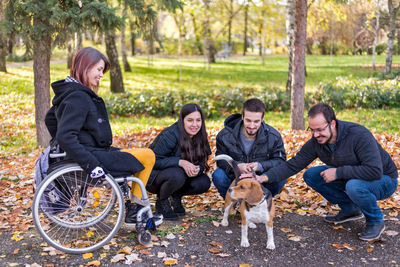 Men and dog on people in park