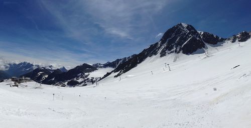 Scenic view of snow covered mountains against sky