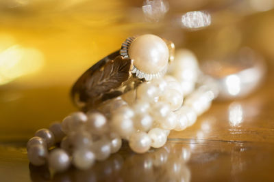 Close-up of pearl jewelries on table