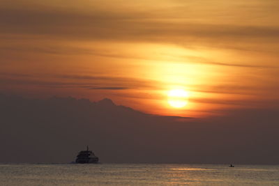 Scenic view of sea against orange sky