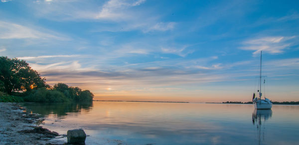 Scenic view of sea against sky at sunset