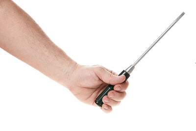 Close-up of hand holding cigarette over white background