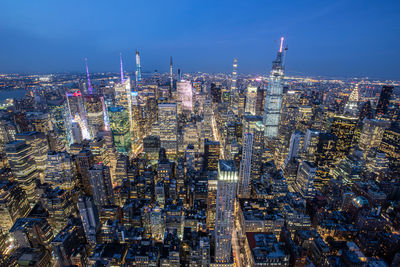 High angle view of illuminated city buildings against sky