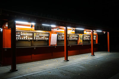 Train at railroad station platform at night