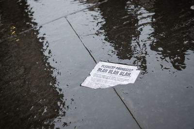 High angle view of reflection in puddle on street