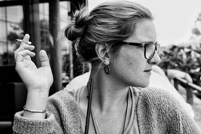 Close-up of young woman holding cigarette