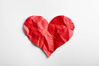 Close-up of red heart shape against white background