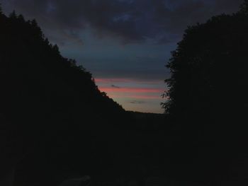 Low angle view of silhouette trees against sky at sunset