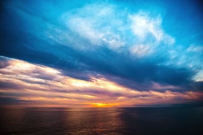 Scenic view of sea against dramatic sky